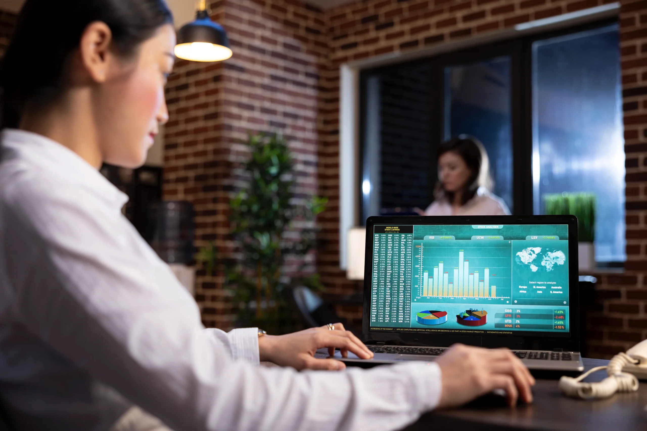 Woman presenting to a group with a stock chart 